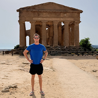 Image of Daniel Rose standing in front of an ancient structure